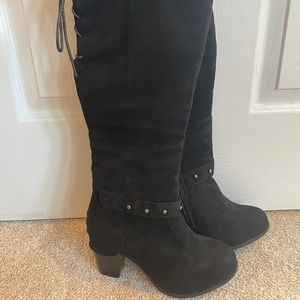 Knee high black lace up boots with a heel